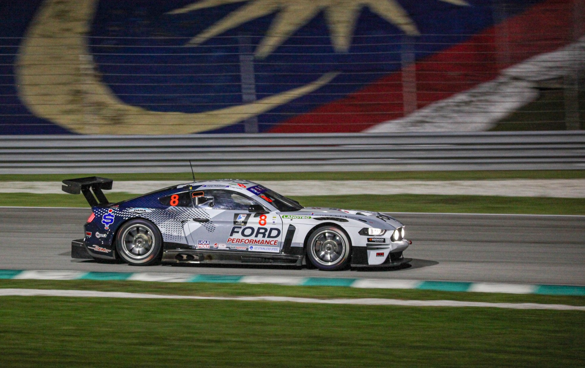 Supercar on the track with Lanotec logo visible