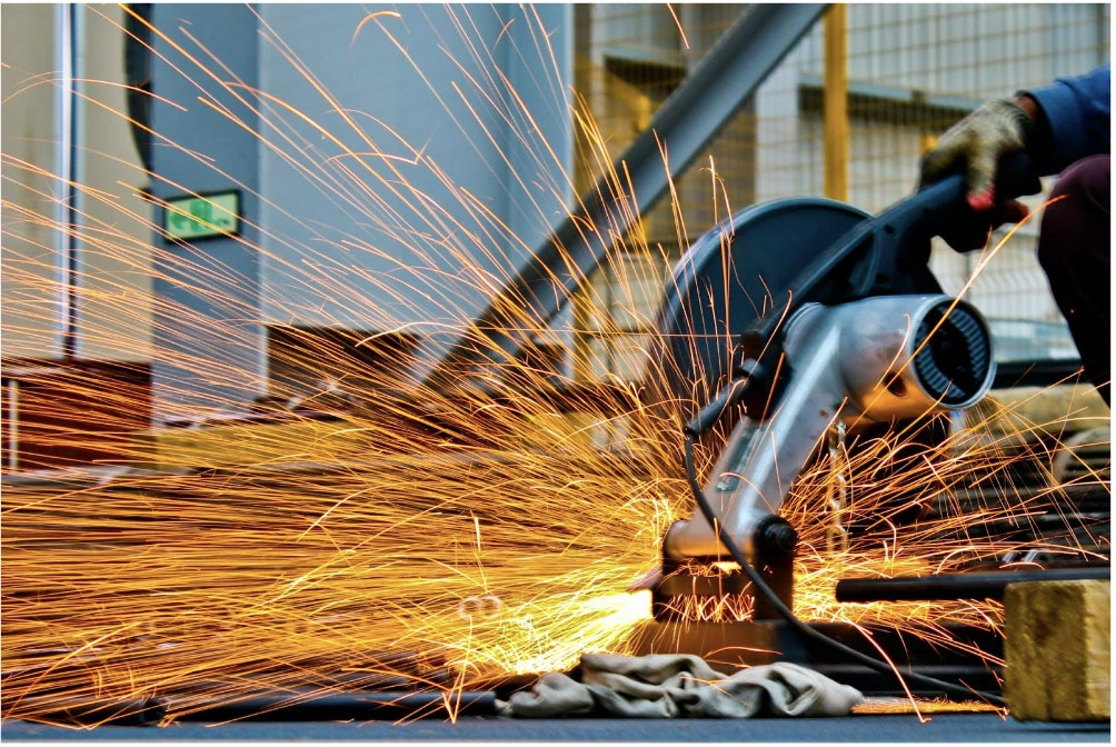 Worker cutting steal and producing lots of sparks